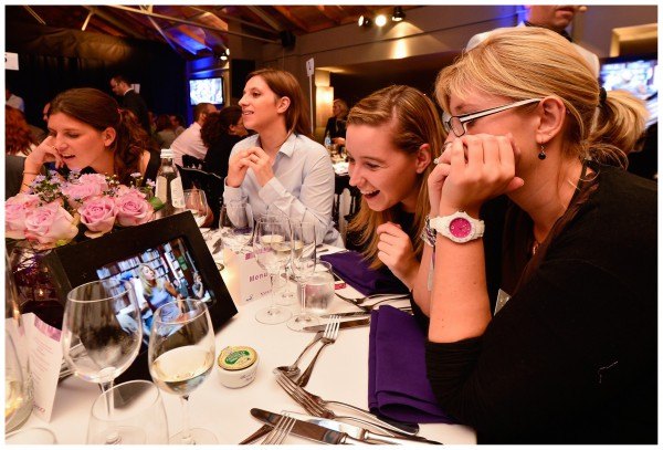 Participants playing an iPad quiz around a table