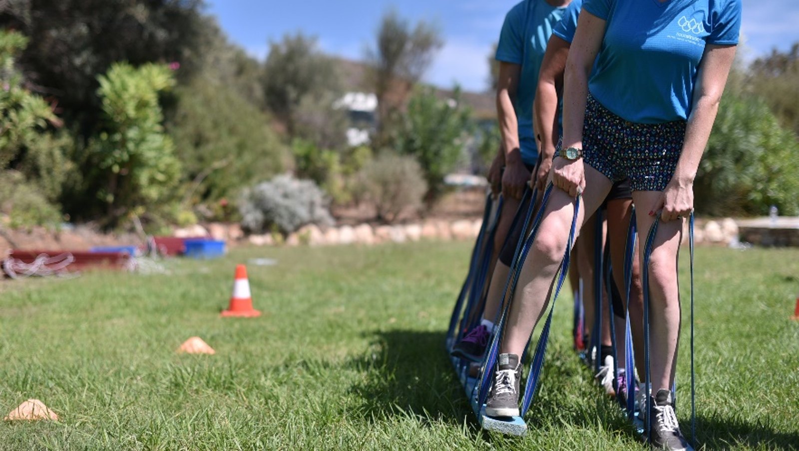 Participants in a grassy area during a team challenge