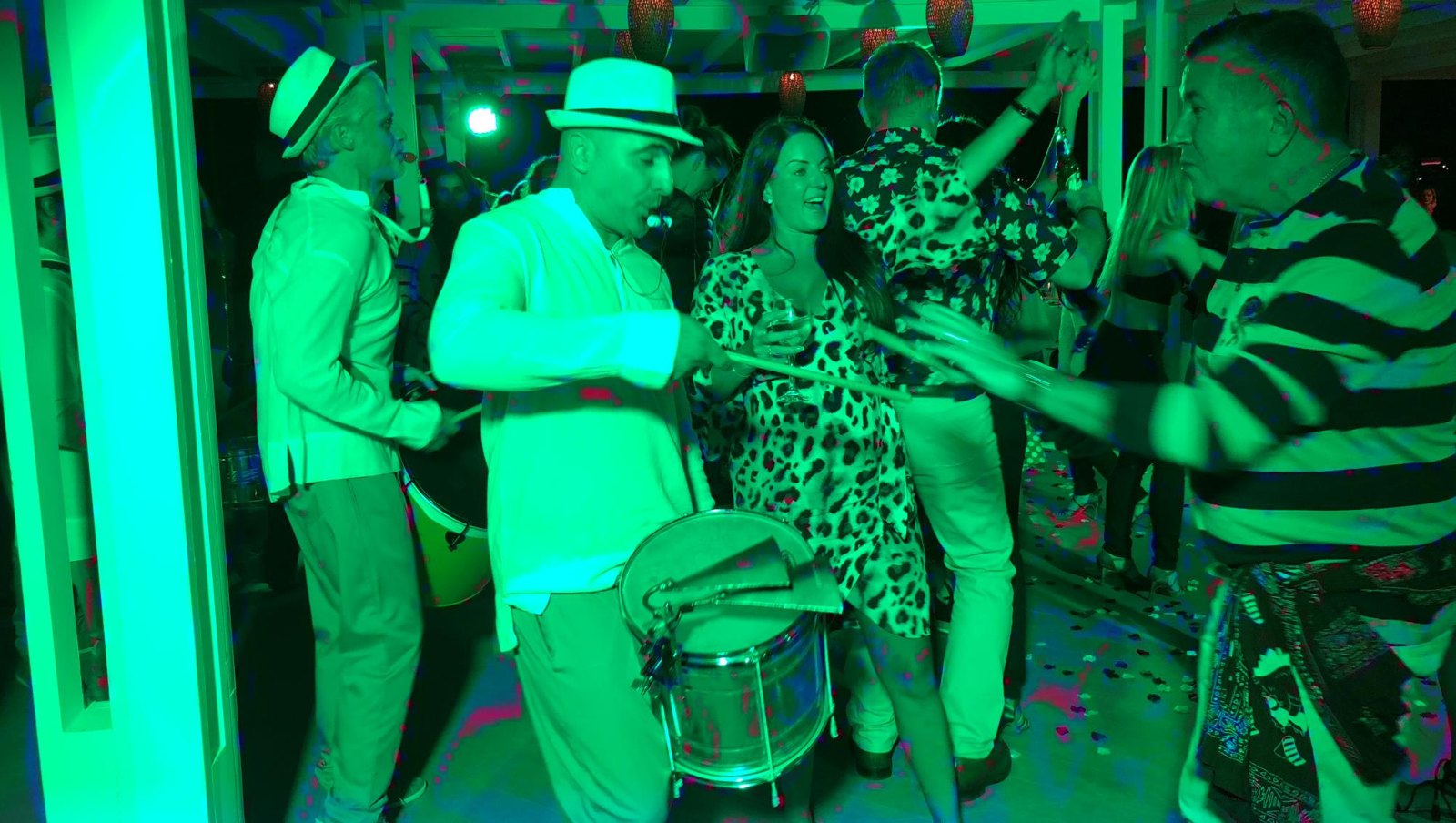 Percussionists playing among party guests