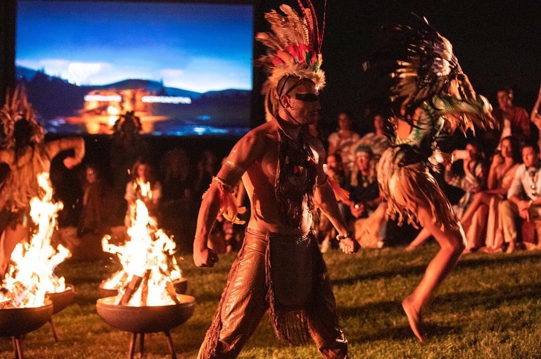 Costumed performers in a theatrical bohemian dance scene