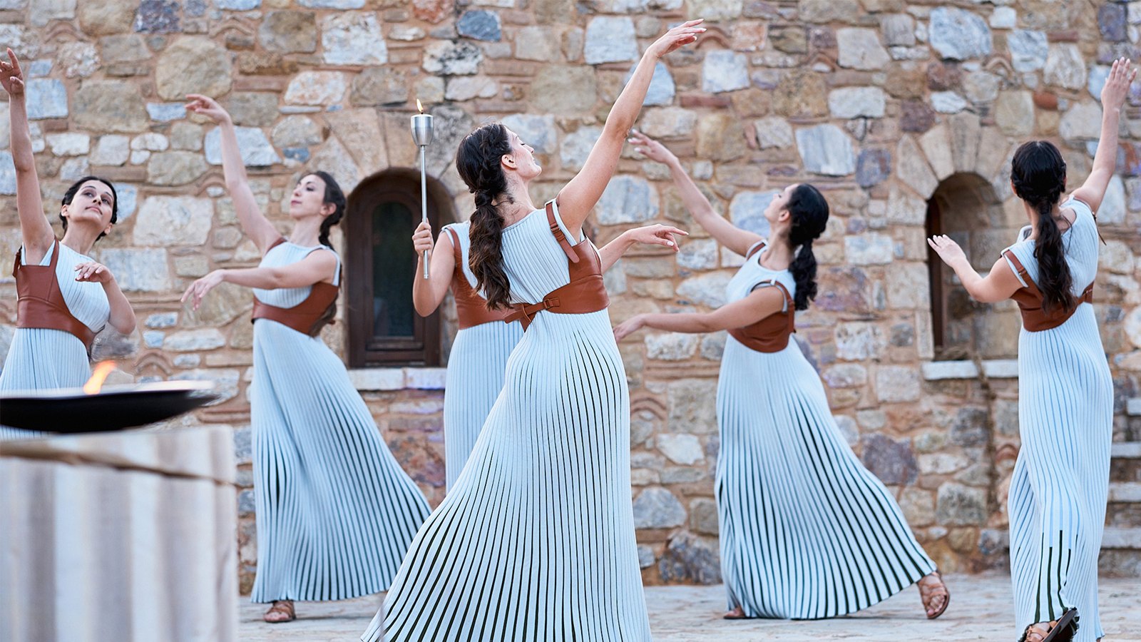 Performers in an Olympic-inspired flame ceremony