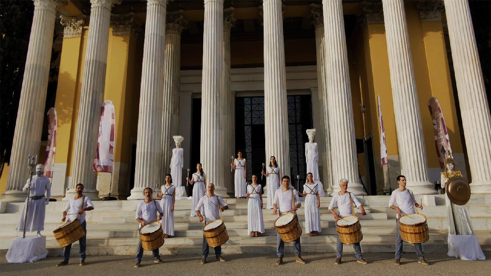 Olympic drummers at a colonnaded entrance