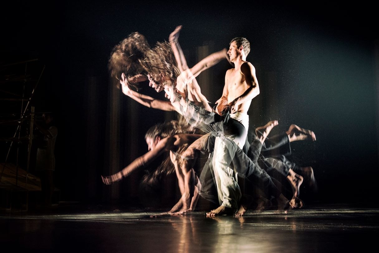 Dancers performing an athletic contemporary choreography