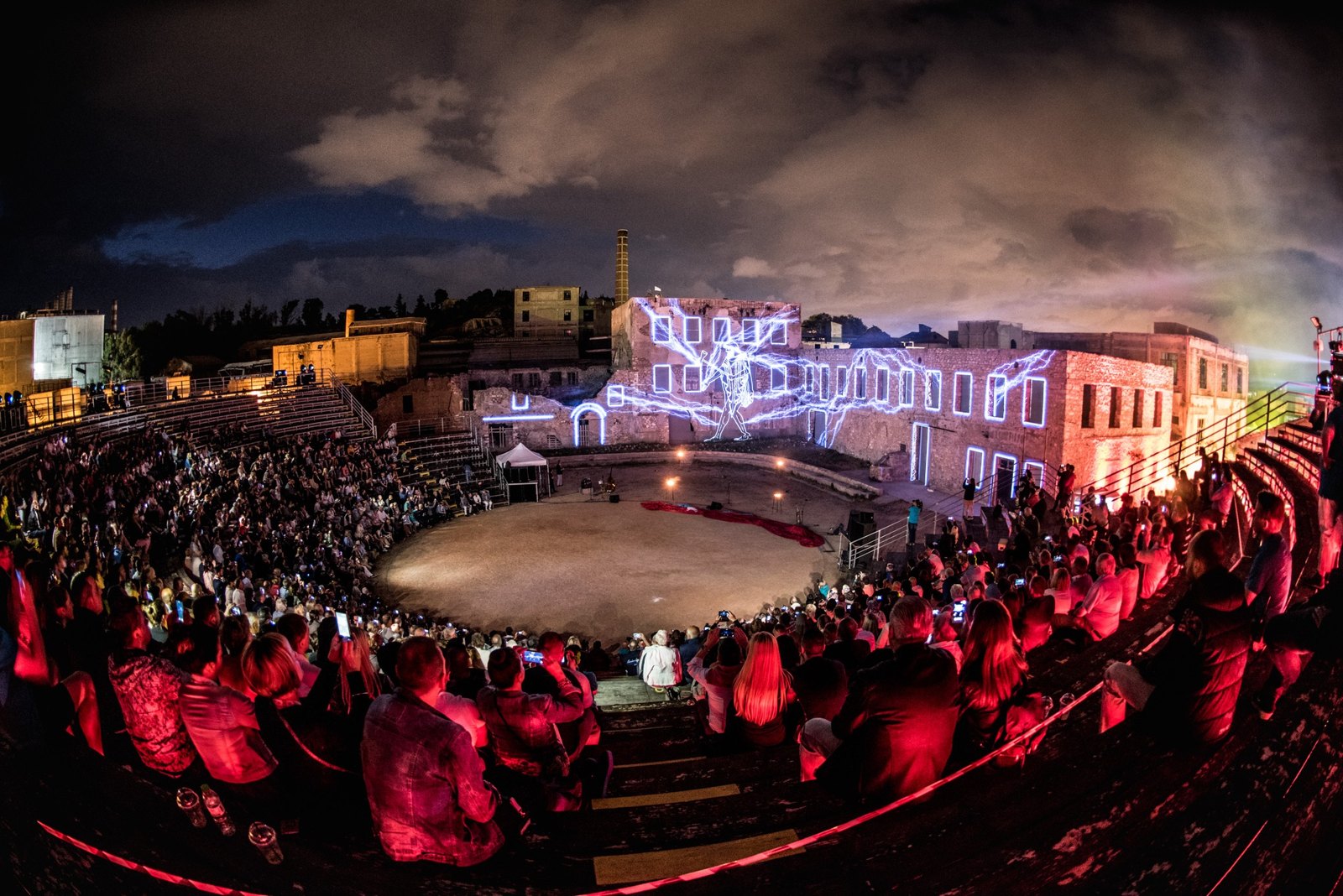 Audience gathered for an outdoor Earth and Fire spectacle