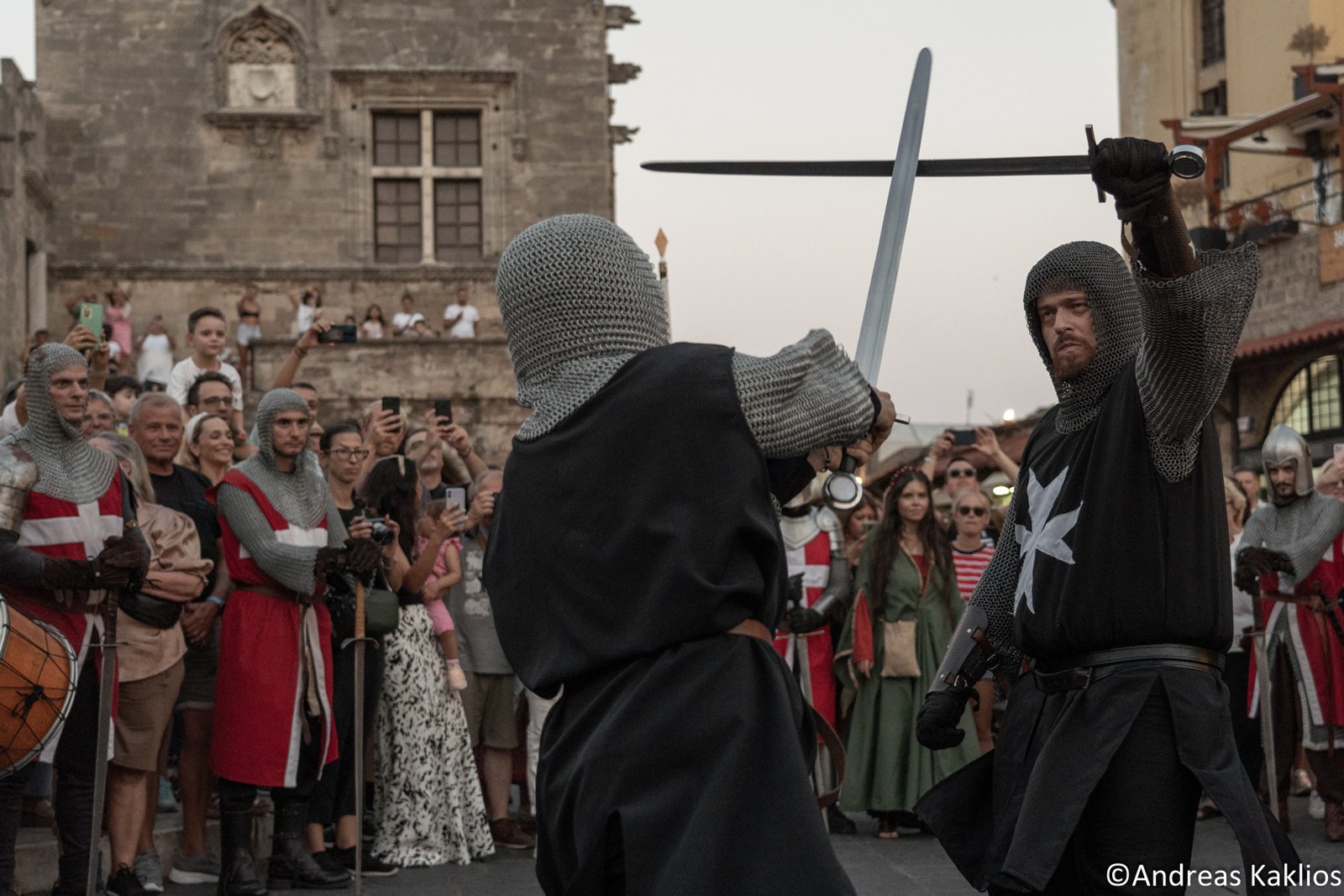 Costumed knights performing a staged sword fight