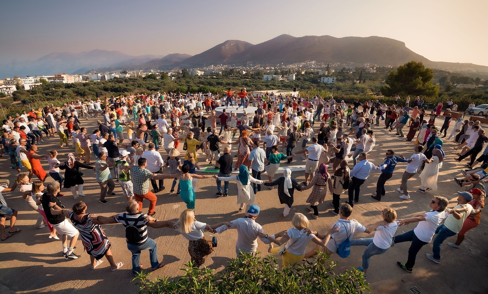 A group dancing Sirtaki together outdoors