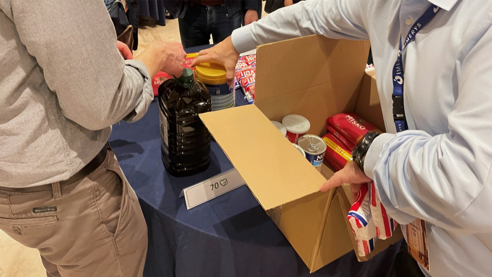 Participants collecting food supplies for a team donation package