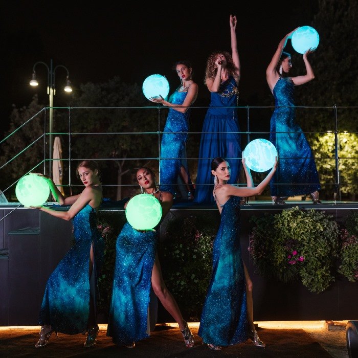Dancers performing with glowing LED spheres