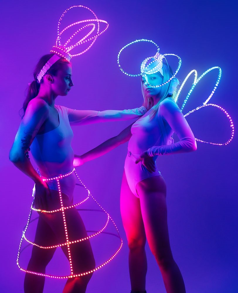 Performers wearing neon light accessories