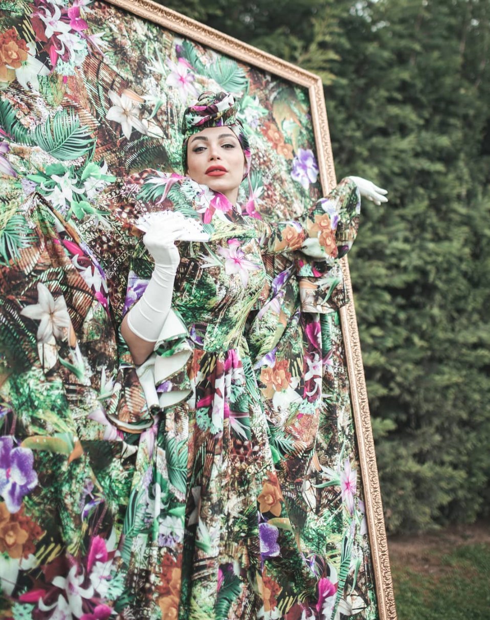 Performer inside a floral living-picture frame