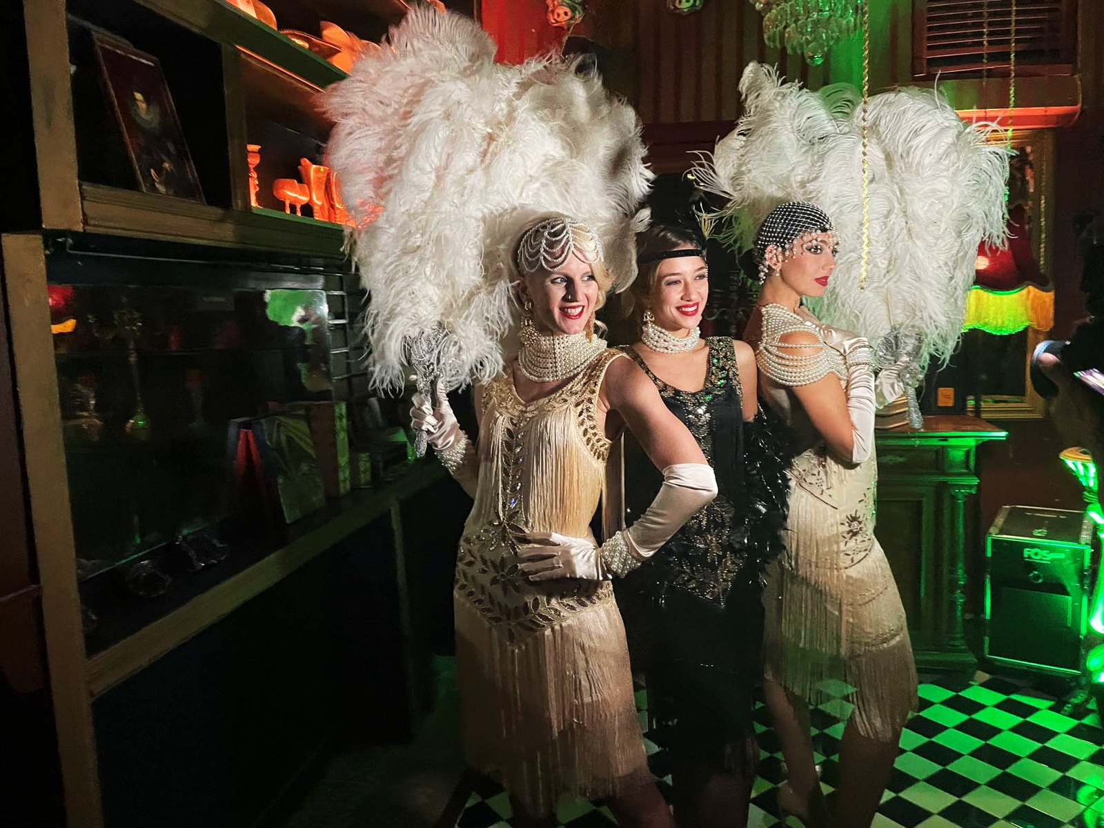 Performers in feathered 1920s costumes
