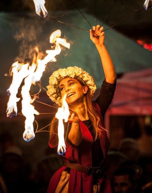Circus fire performer with illuminated props