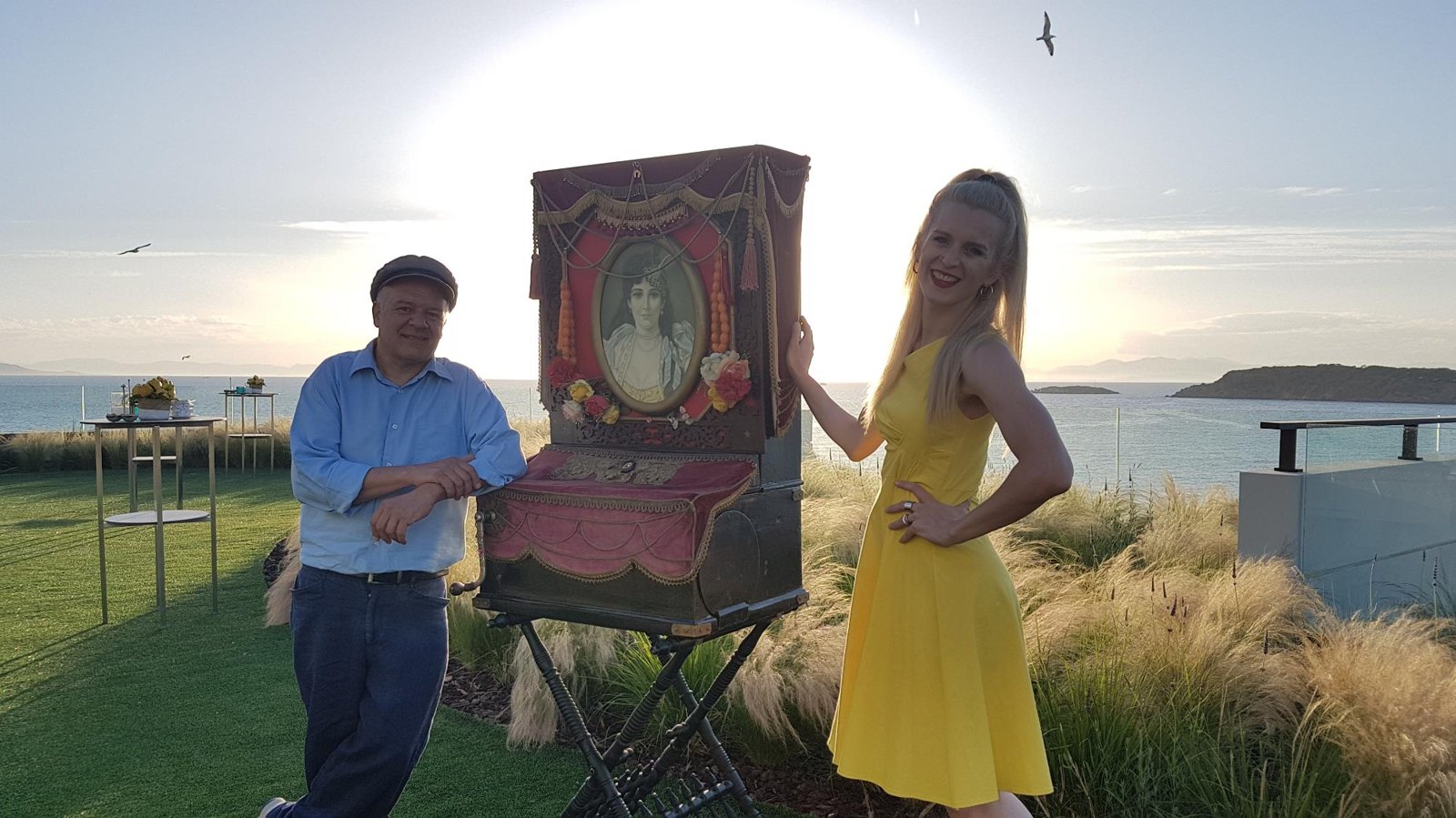 Barrel organ performer and guest at a coastal event