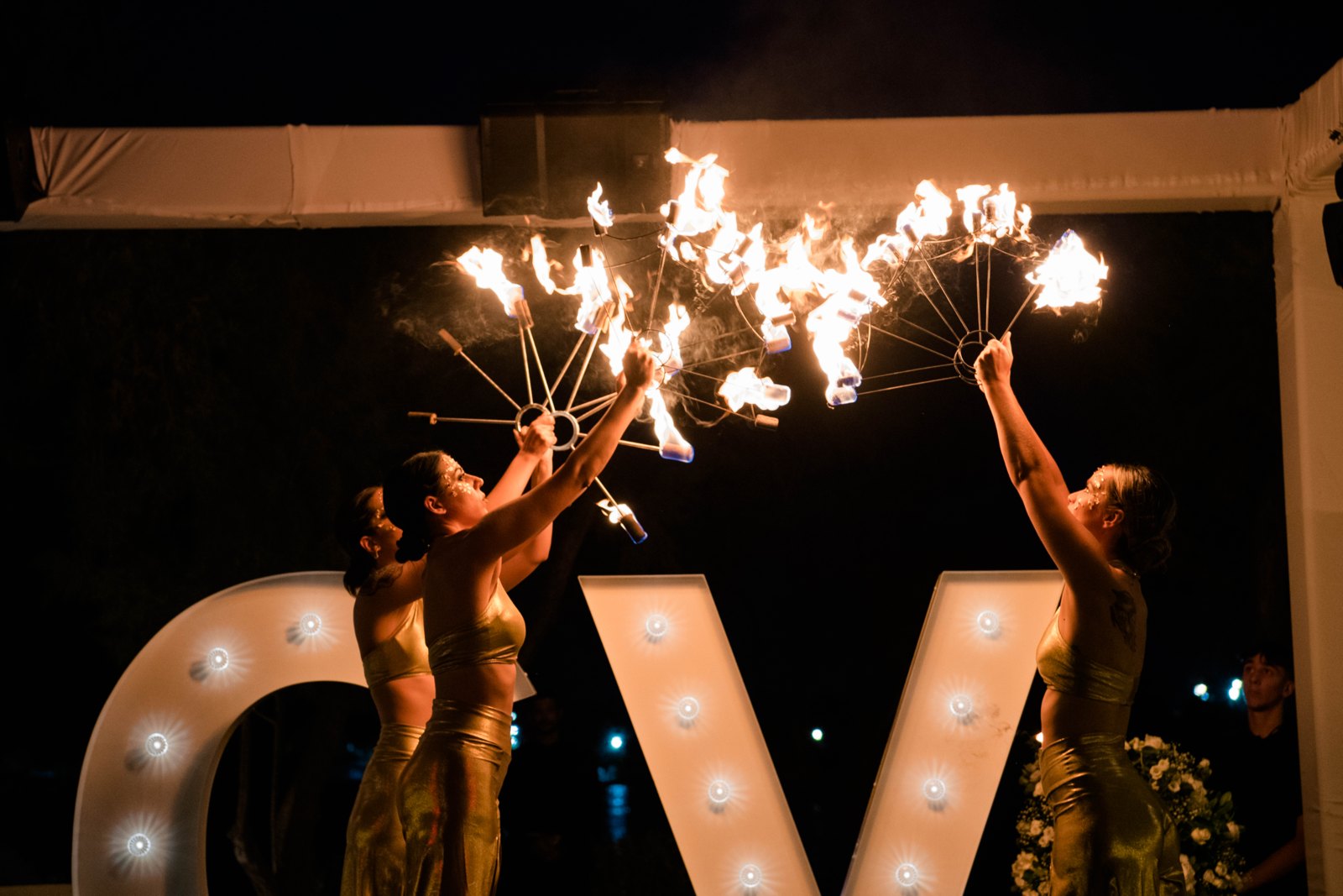 Maenad-inspired performers dancing with fire fans