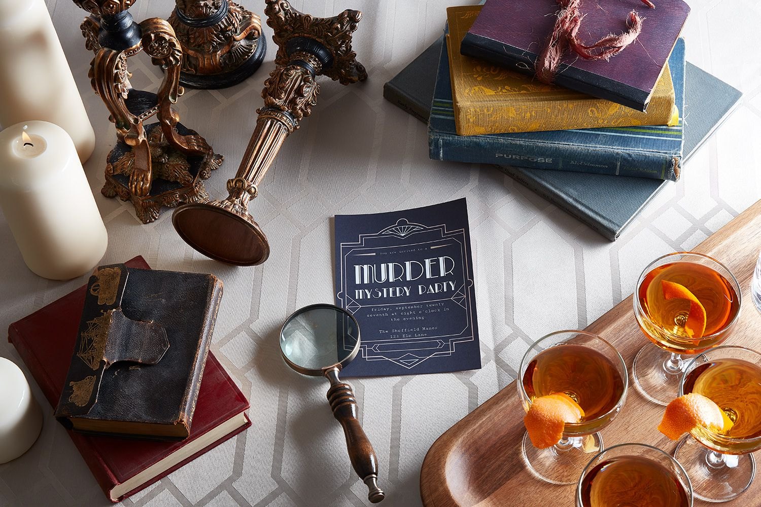 Mystery-night table with clues, books, magnifying glass and props