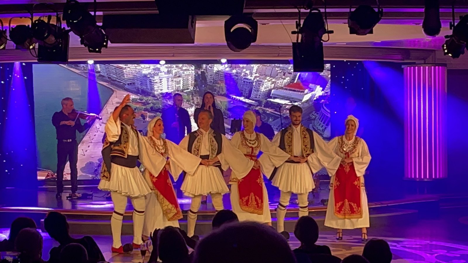 Performers in traditional mainland Greek costumes on stage