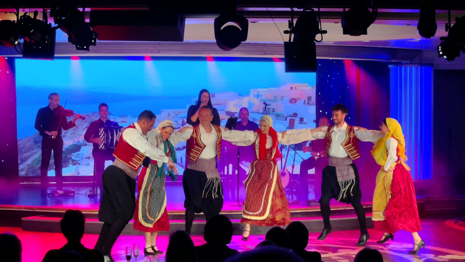 Performers in colourful Greek island costumes