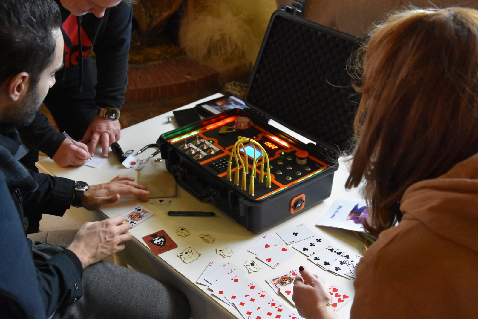 Team working with the mechanisms inside a Pandora puzzle case