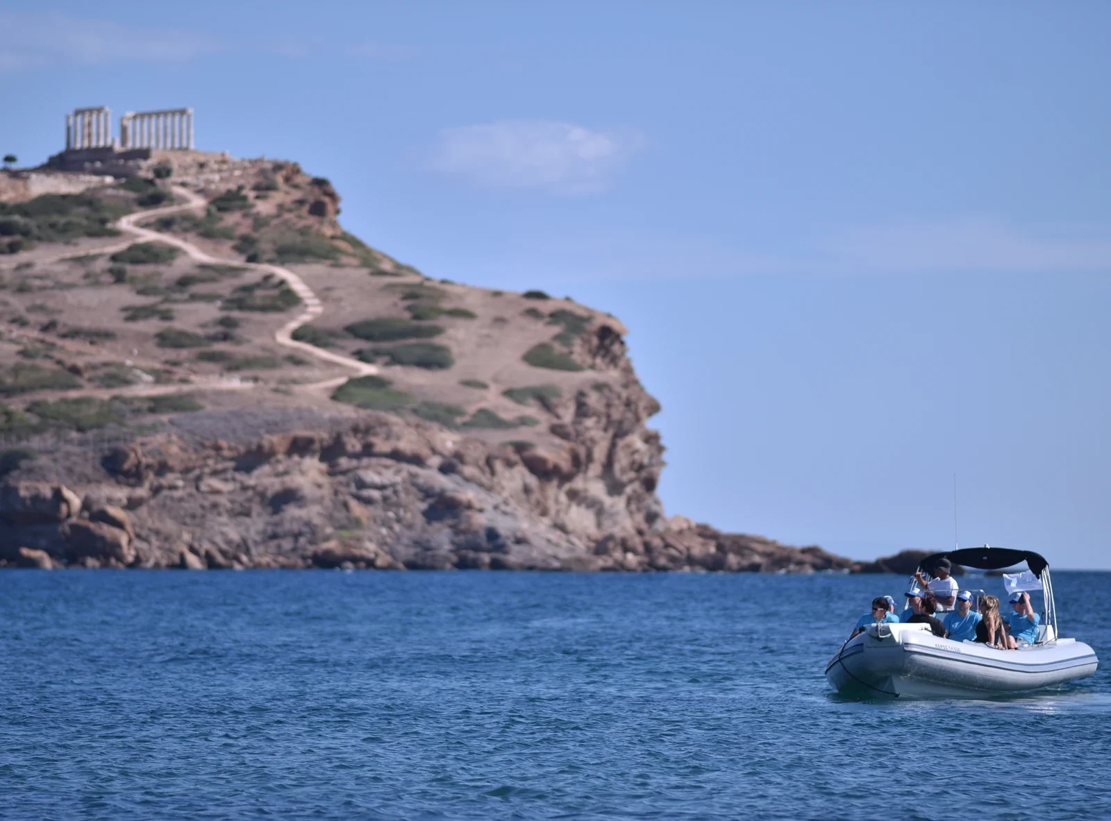 Rigid inflatable boat passing Cape Sounion