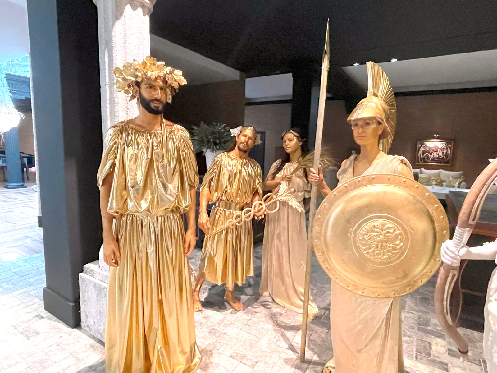 Golden living-statue performers at an event welcome