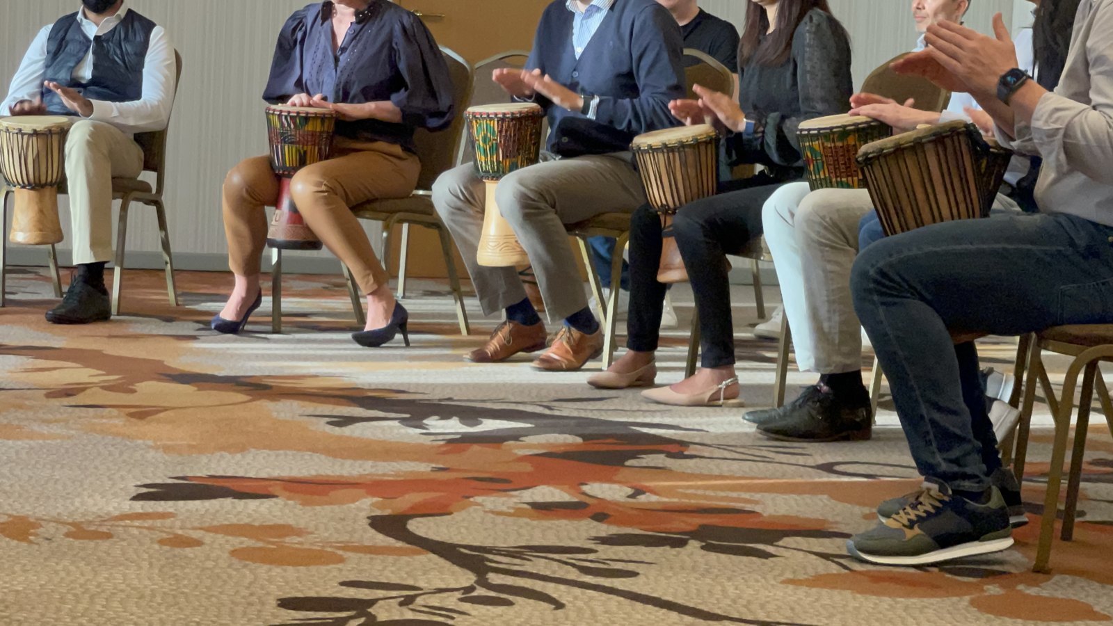 Participants playing hand drums together