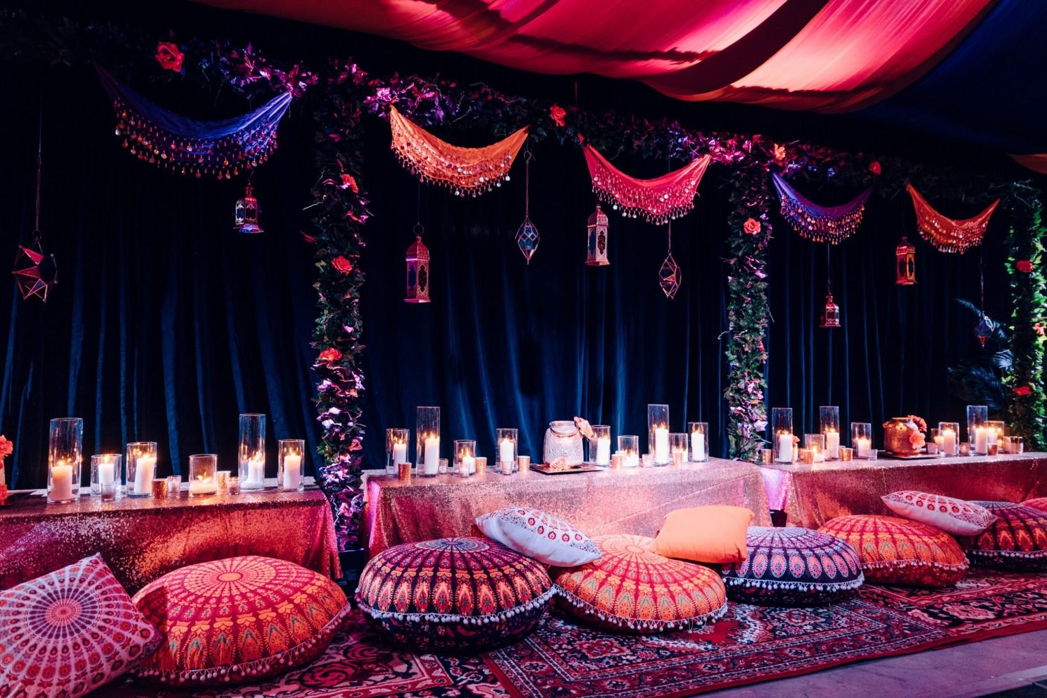 Arabian-inspired event setting with draped fabrics and cushions
