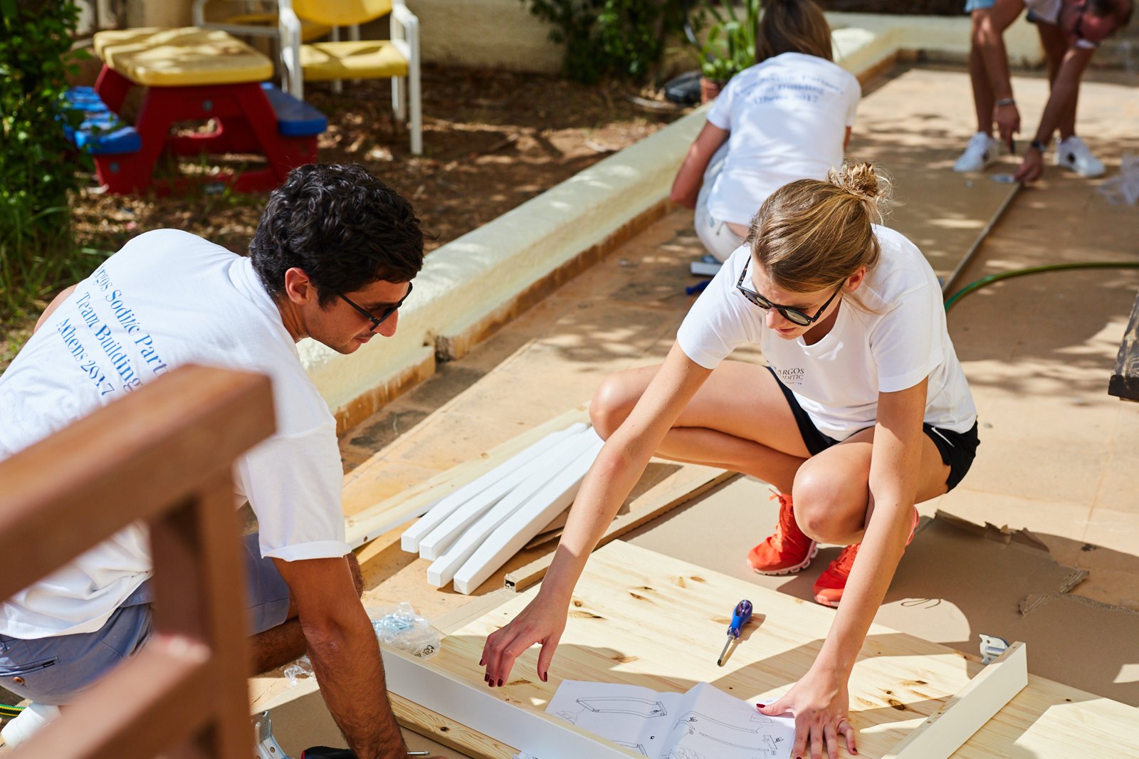 Participants assembling furniture together