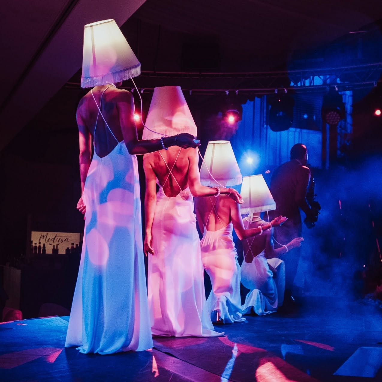 Performers in illuminated lampshade costumes