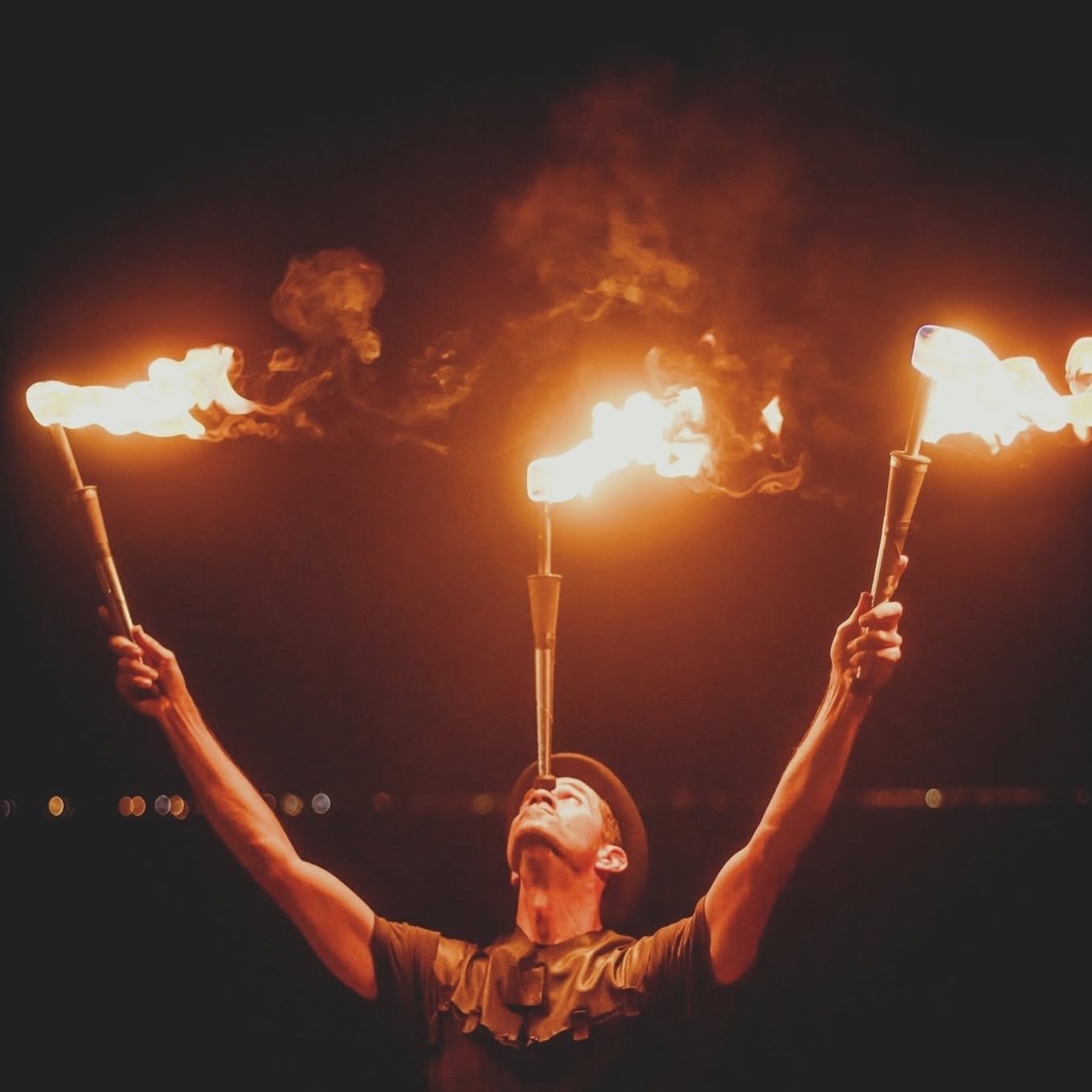Fire juggler performing with flaming props