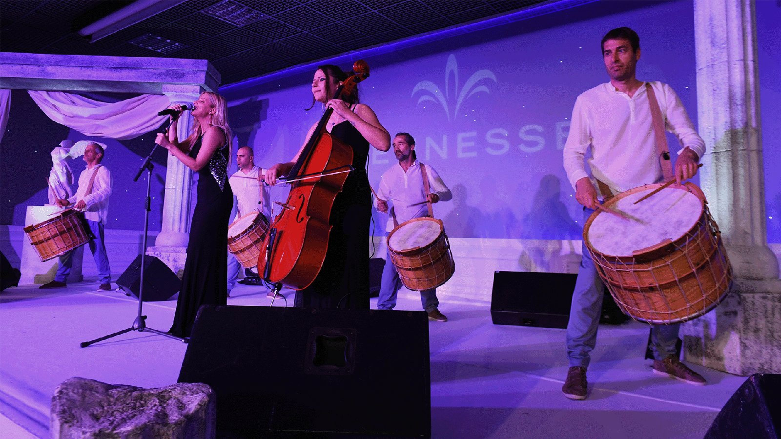 Musicians performing with drums and cello